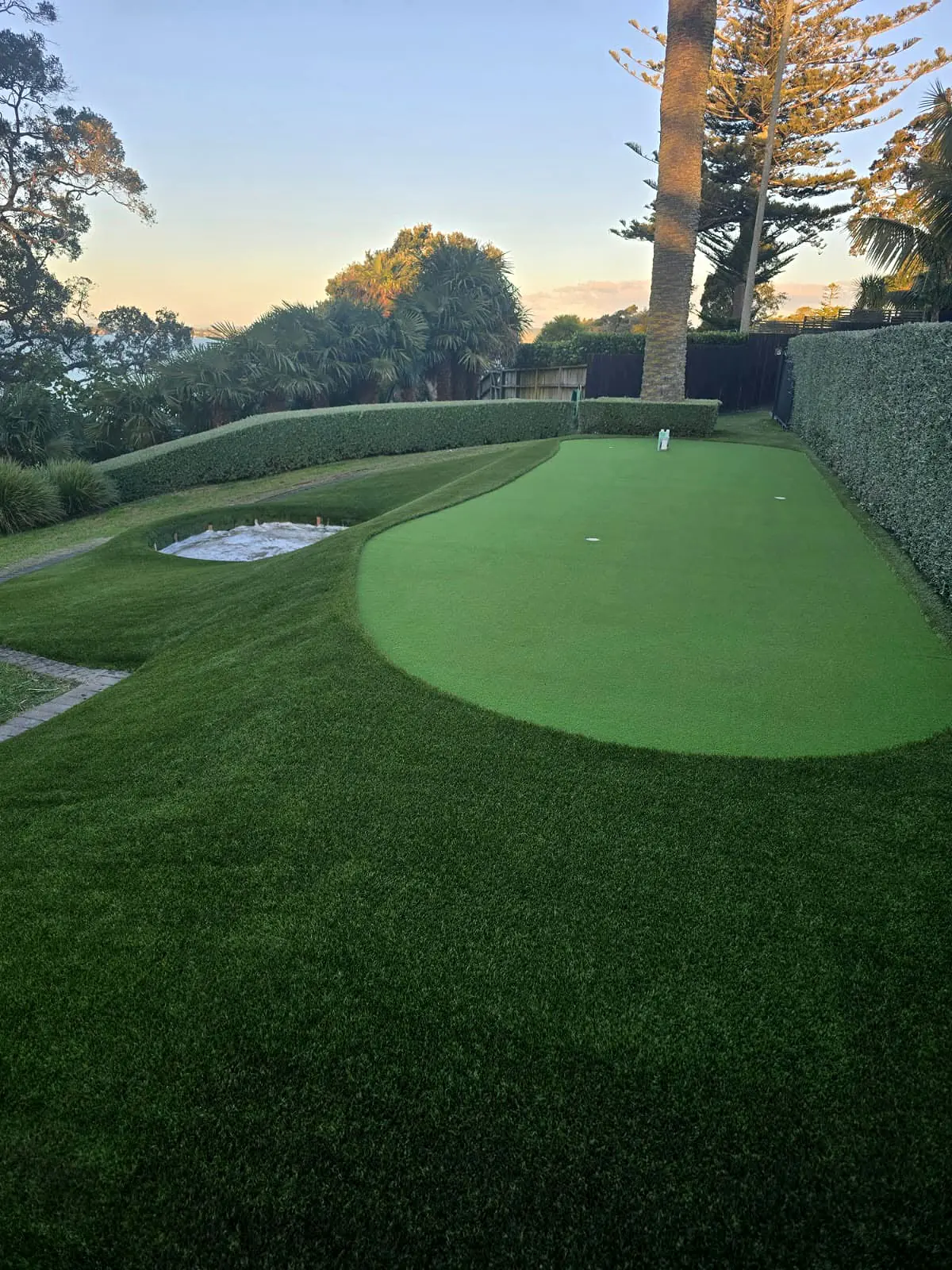 Completed mini golf putting green integrated into a landscaped garden