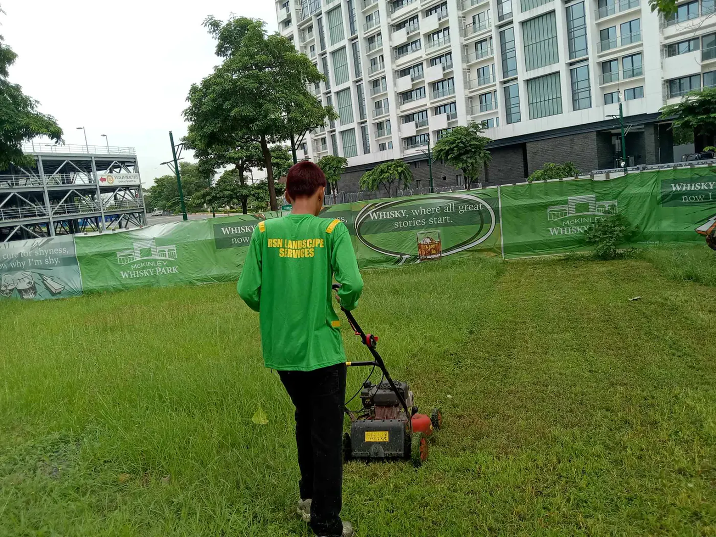 RSN crew member mowing landscaped commercial grounds
