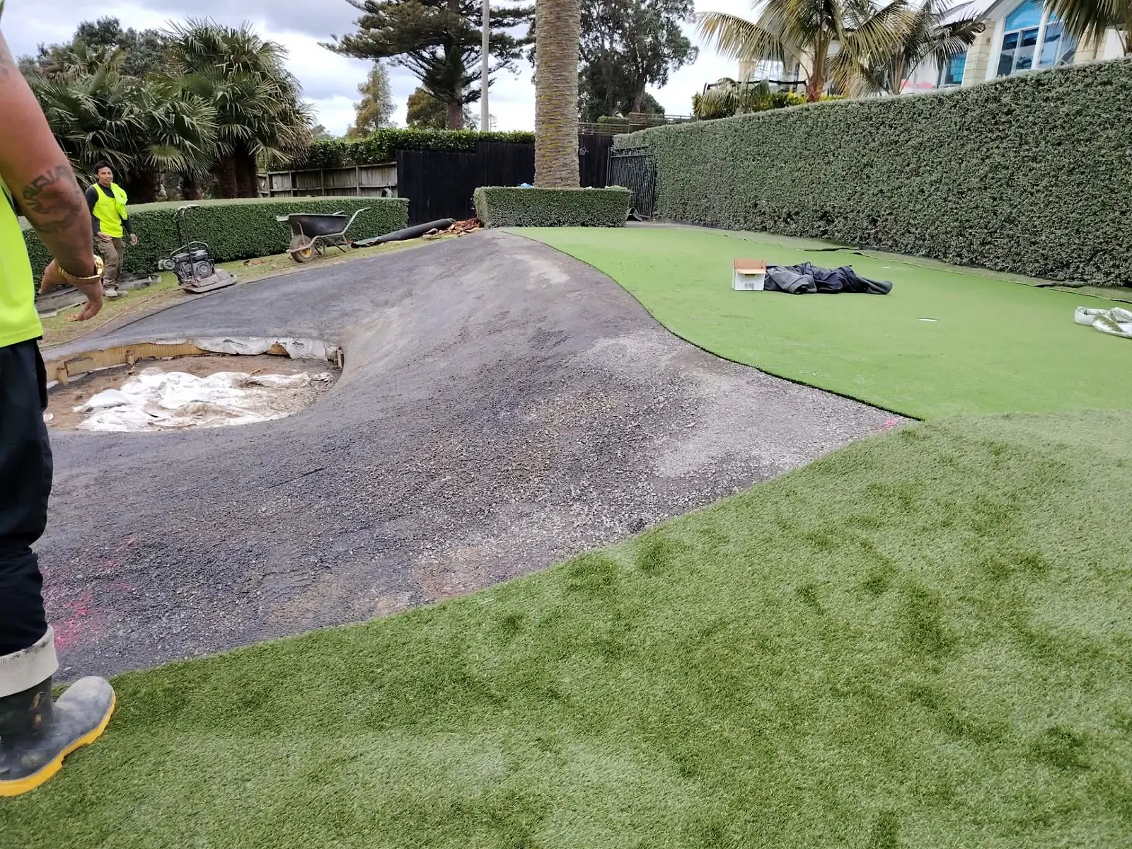 Artificial turf being fitted for a custom mini golf course