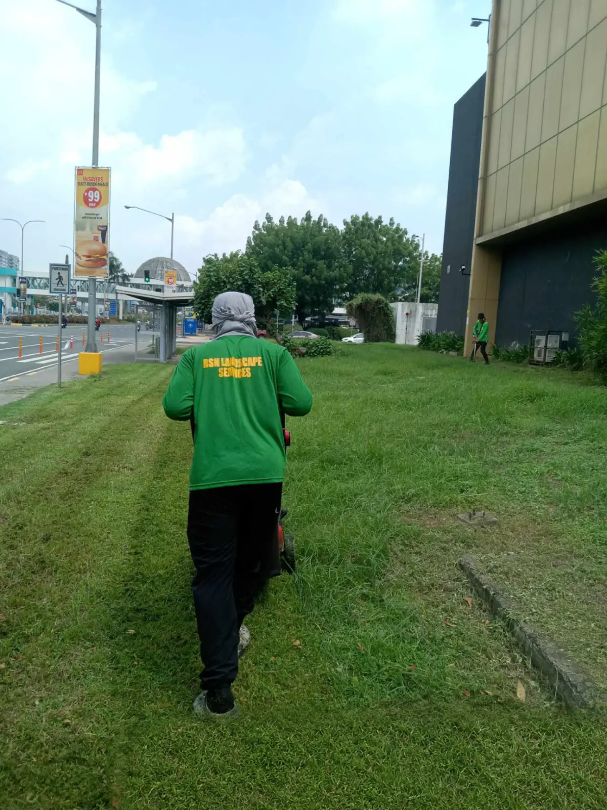 RSN grounds-maintenance worker mowing a commercial lawn